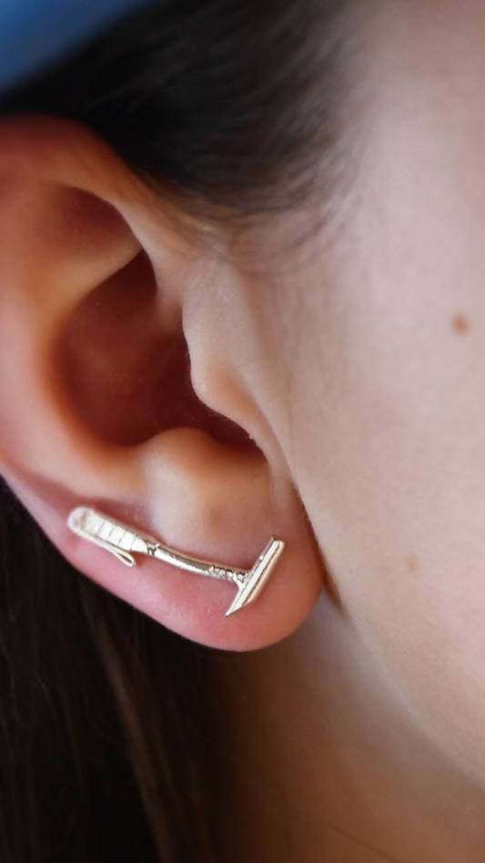 Sterling silver polo mallet earring climber shown worn on ear, curving upward along the earlobe — elegant equestrian jewelry for women in polo.