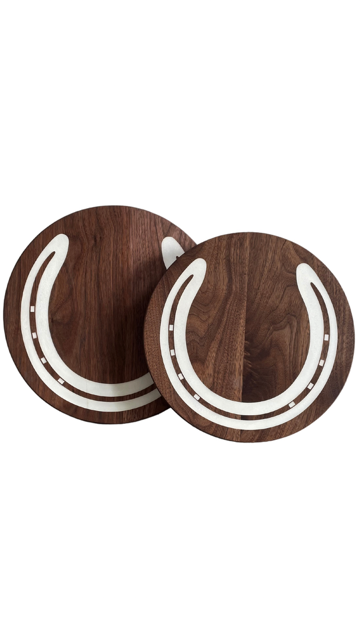 Pair of walnut charcuterie boards with white epoxy horseshoe inlays shown on a white background — handcrafted polo trophies by The Golden Pony.